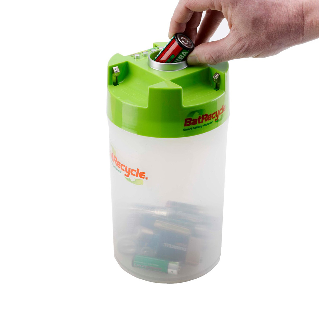 Hand placing used battery in the BatRecycle receptacle lid