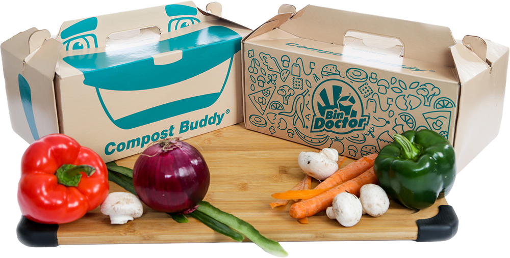 Compost buddy product demo on coating board with vegetables